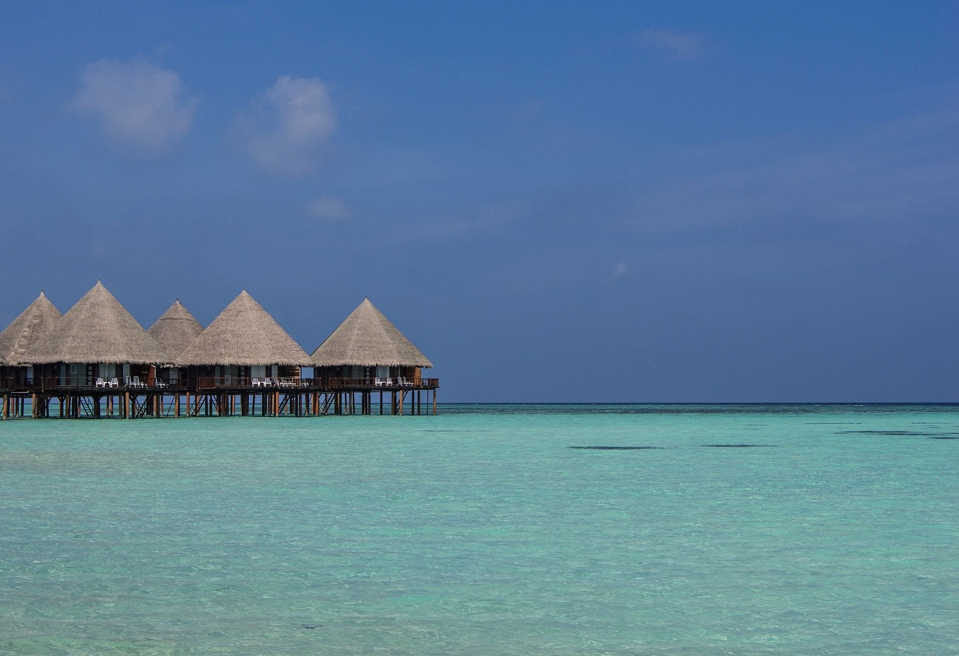 Stunning view of tropical overwater bungalows amidst clear turquoise waters in the Maldives.